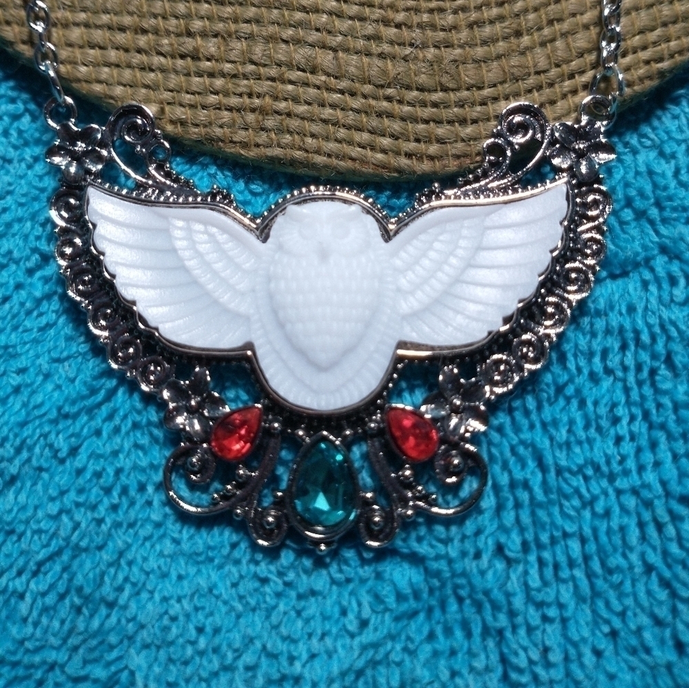 Silvertone white blue red owl wings necklace